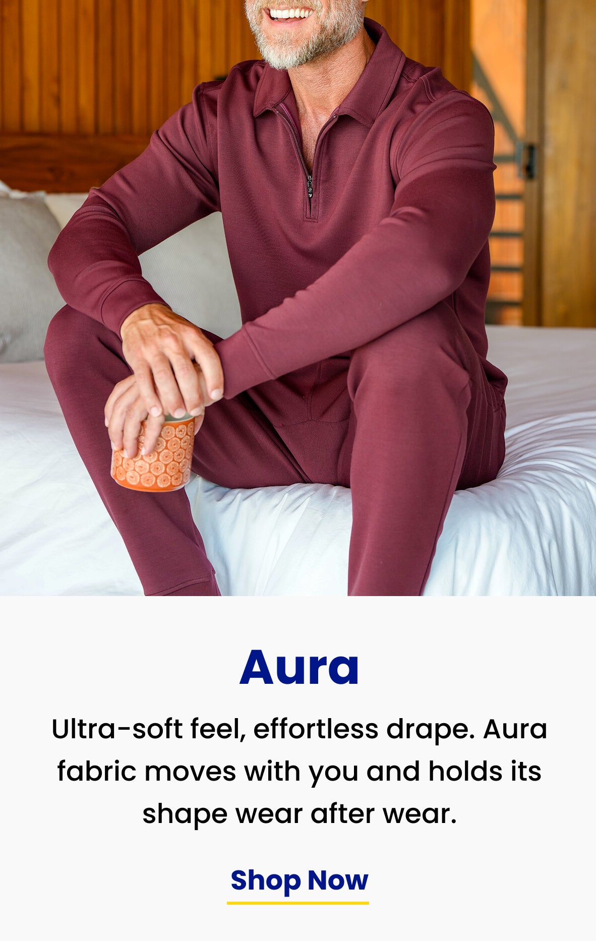 ultra-soft feel, effortless drape. Burgundy Aura Zip Polo and joggers, seated on a bed
