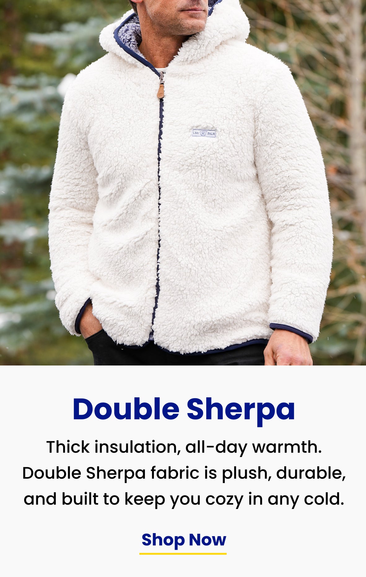 thick insulation, all-day warmth. White and navy reversible sherpa full-zip hoodie, hood down, under evergreens